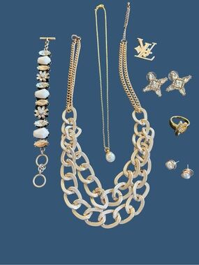 Gold-Tone Necklace, pearl necklace, rhinestone bracelet, brooch, earrings, ring.
